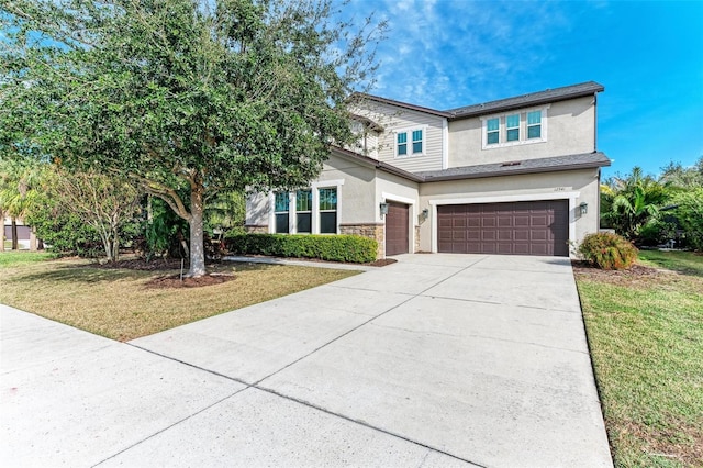 view of front of home with a garage and a front lawn