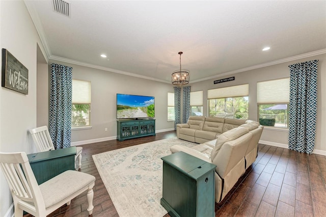 living room with a notable chandelier and crown molding