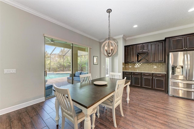 dining area featuring dark wood-type flooring, a textured ceiling, and ornamental molding