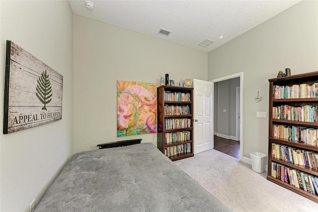 carpeted bedroom featuring a textured ceiling