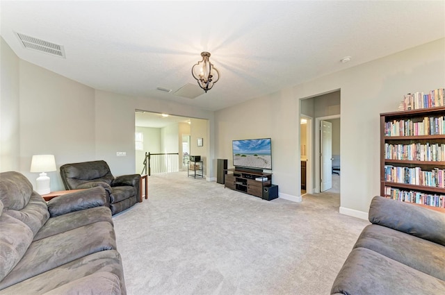 living room with visible vents, light carpet, a notable chandelier, and baseboards