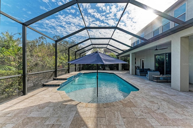 outdoor pool with glass enclosure, a patio, ceiling fan, and outdoor lounge area