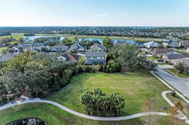 drone / aerial view featuring a residential view and a water view