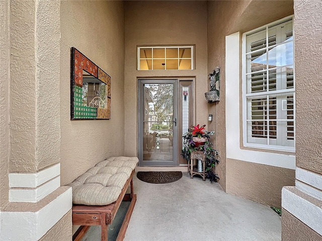 view of exterior entry featuring stucco siding