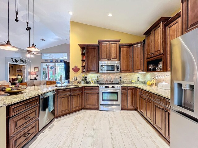 kitchen with open shelves, appliances with stainless steel finishes, a peninsula, and a sink