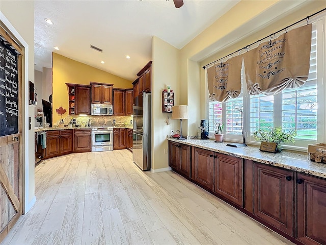 kitchen with light stone counters, visible vents, appliances with stainless steel finishes, decorative backsplash, and open shelves