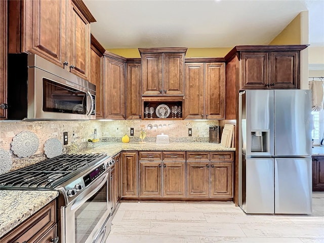 kitchen with light stone counters, open shelves, light wood-style flooring, decorative backsplash, and appliances with stainless steel finishes