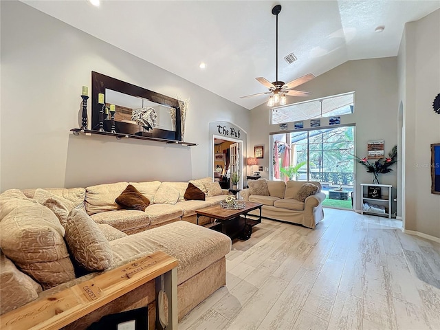 living room with high vaulted ceiling, light wood-style flooring, visible vents, and a ceiling fan