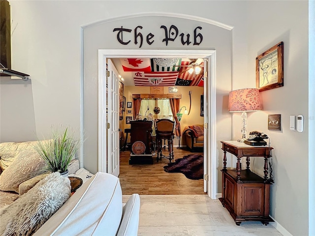 hallway with light wood-style flooring and baseboards