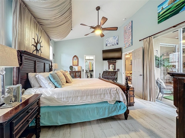 bedroom with access to exterior, a ceiling fan, high vaulted ceiling, and wood finished floors