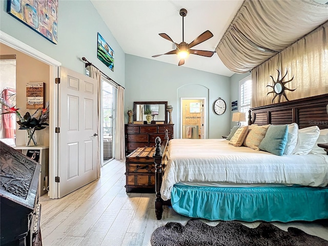 bedroom featuring connected bathroom, lofted ceiling, ceiling fan, and wood finished floors