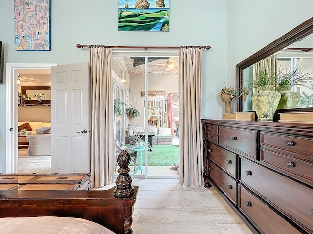 bedroom with access to outside and light wood-style flooring