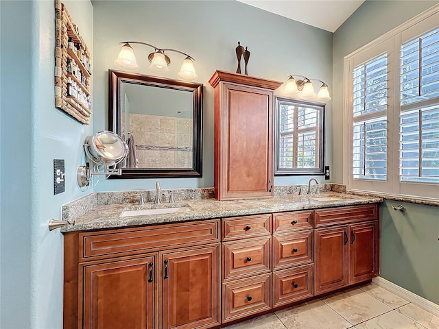 bathroom featuring a sink and double vanity