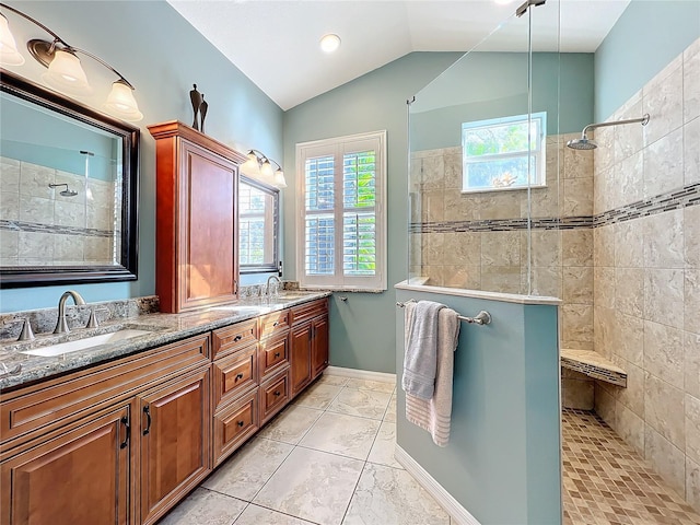 full bathroom featuring lofted ceiling, double vanity, walk in shower, and a sink