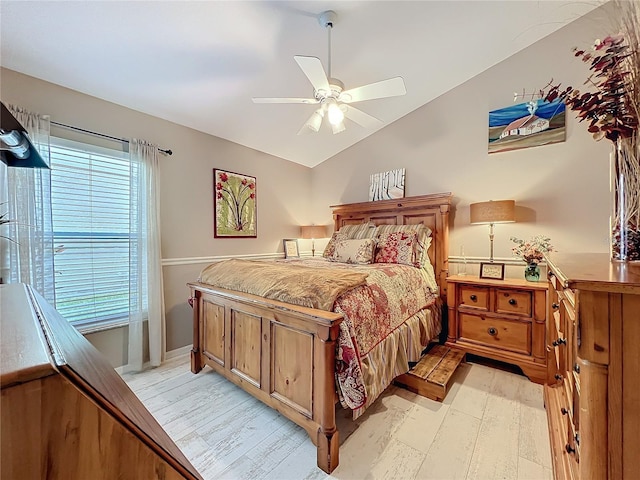 bedroom with lofted ceiling, ceiling fan, and light wood-type flooring