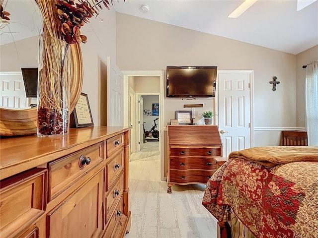 bedroom with lofted ceiling and light wood-type flooring