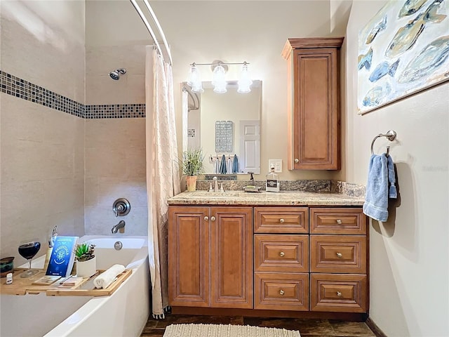 bathroom featuring shower / bath combo with shower curtain and vanity