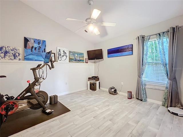 exercise room featuring baseboards, a ceiling fan, vaulted ceiling, and wood finished floors