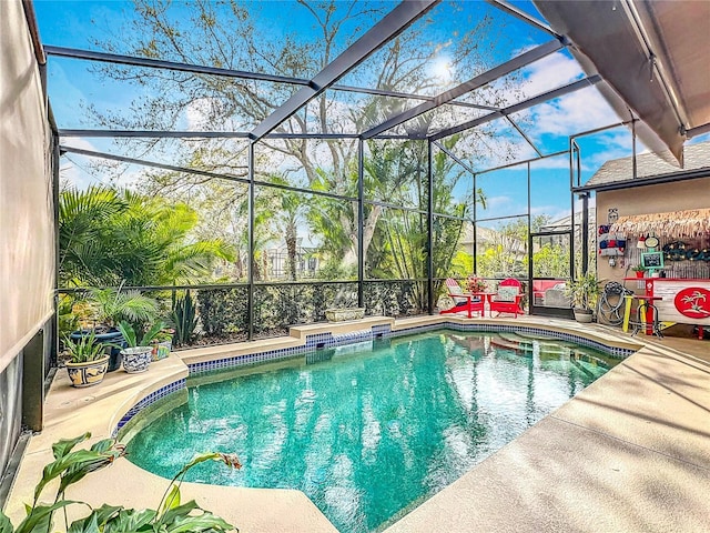 outdoor pool with a patio and a lanai