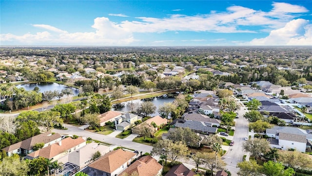 bird's eye view featuring a water view and a residential view