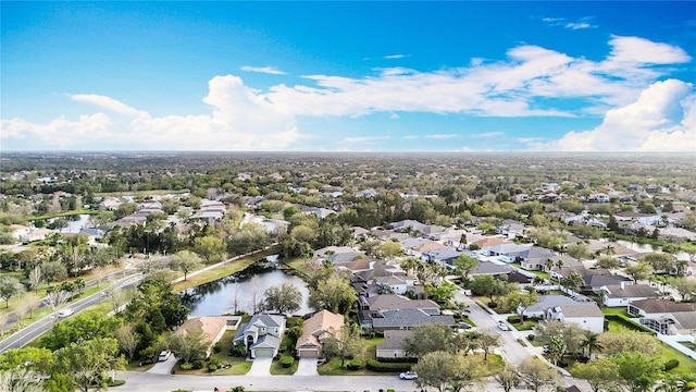 drone / aerial view with a water view and a residential view