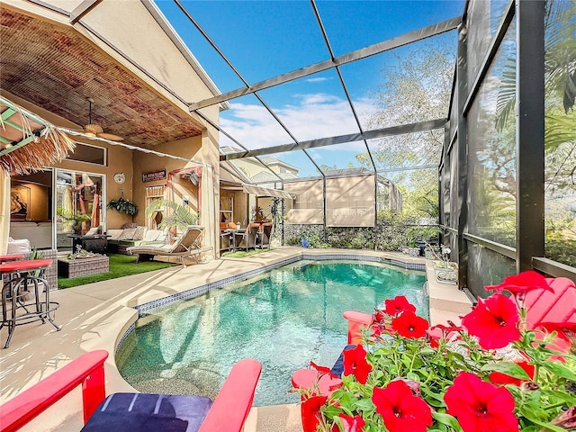 outdoor pool featuring ceiling fan, a patio, an outdoor hangout area, and a lanai