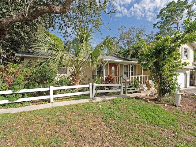 view of front of home with a front yard and covered porch