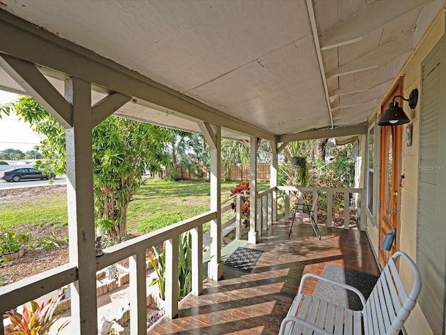 wooden terrace featuring covered porch