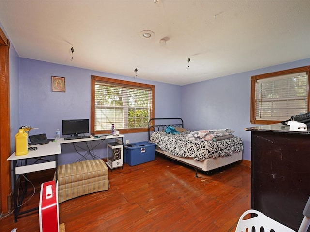 bedroom with dark hardwood / wood-style flooring