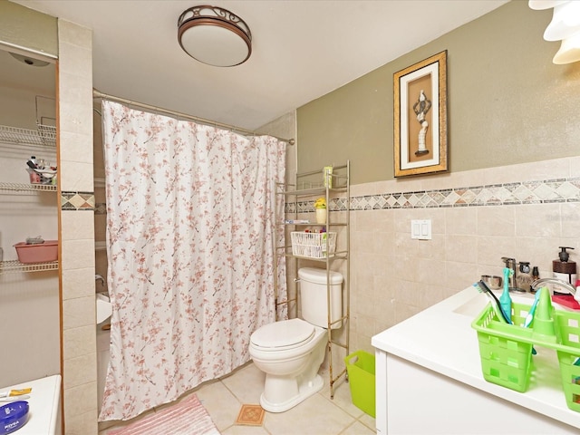 bathroom with tile walls, tile patterned flooring, a shower with shower curtain, vanity, and toilet