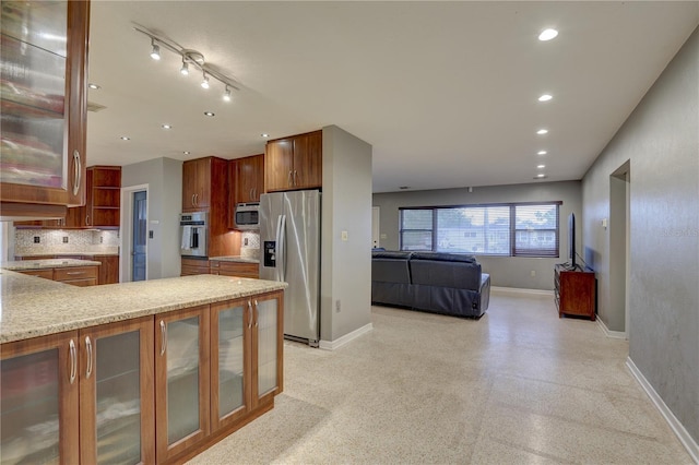 kitchen with appliances with stainless steel finishes and backsplash