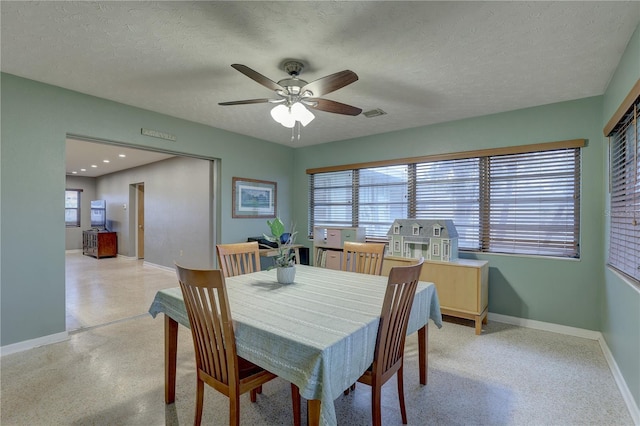 dining space featuring a textured ceiling, ceiling fan, and a healthy amount of sunlight