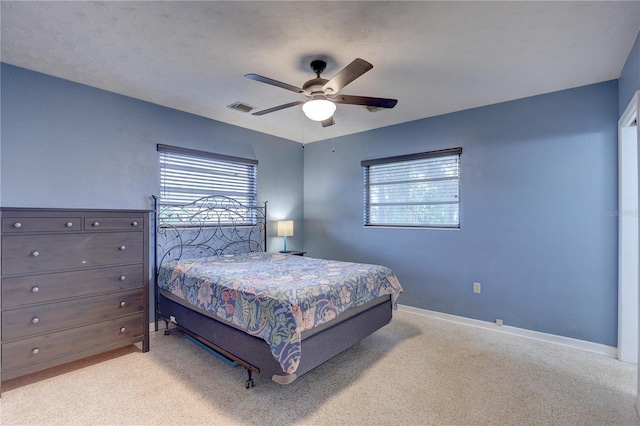 bedroom with ceiling fan and a textured ceiling