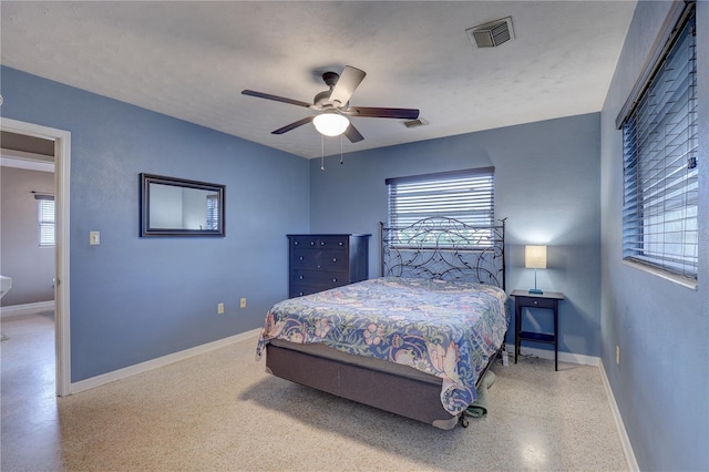 bedroom featuring ceiling fan and a textured ceiling