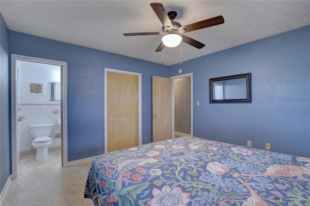 bedroom with ceiling fan, tile walls, and connected bathroom