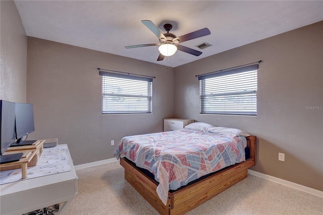 bedroom with multiple windows and ceiling fan