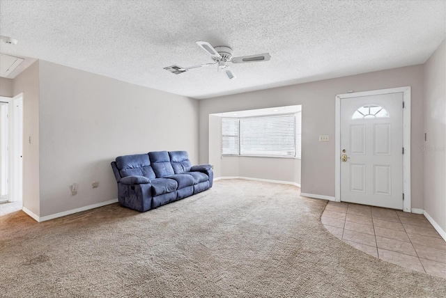 carpeted entryway with a textured ceiling, ceiling fan, and a wealth of natural light