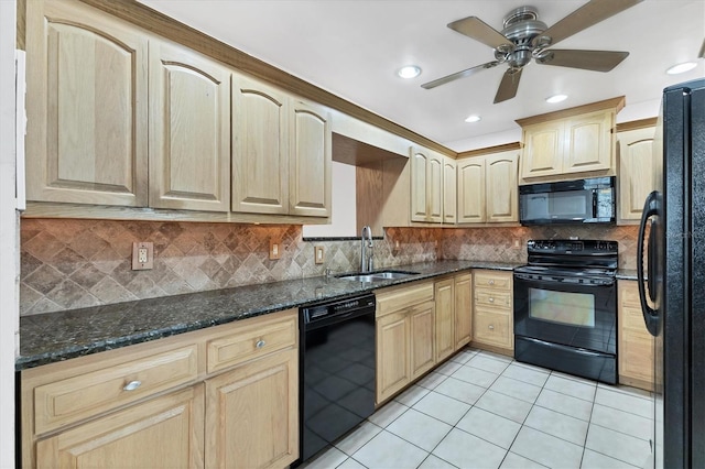 kitchen featuring ceiling fan, dark stone countertops, black appliances, sink, and light tile patterned floors