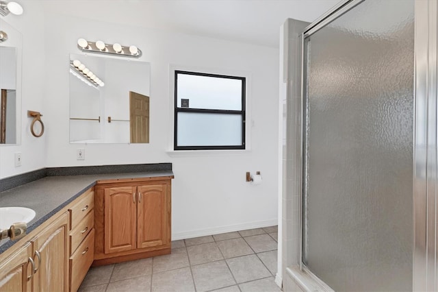 bathroom featuring an enclosed shower, vanity, and tile patterned flooring