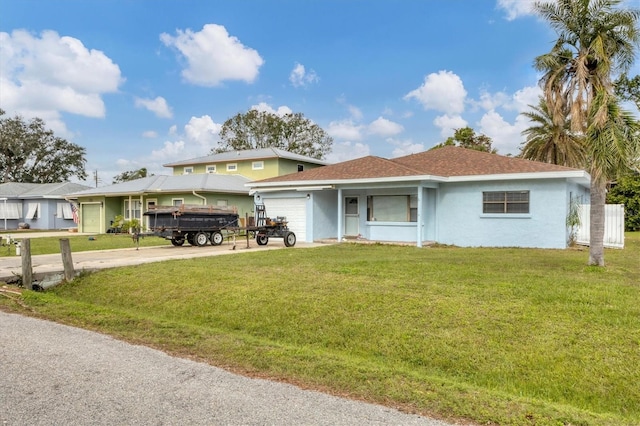 view of front of property with a garage and a front lawn