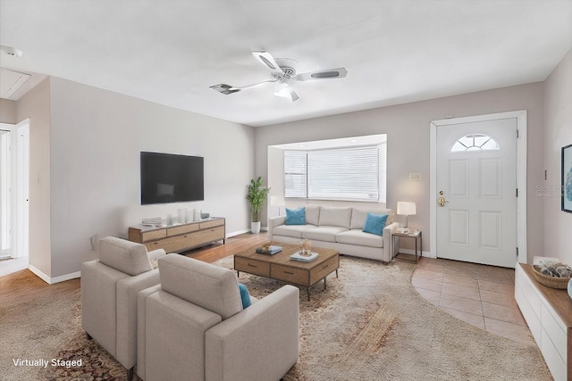 tiled living room with ceiling fan and a healthy amount of sunlight