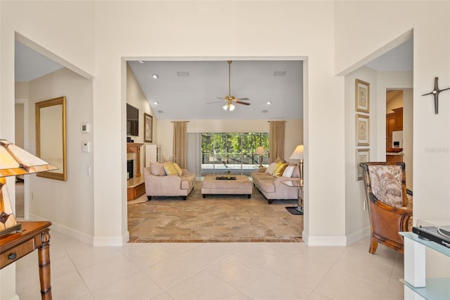 living room with ceiling fan and light tile patterned flooring