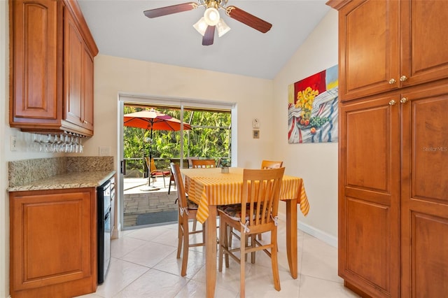 dining space with ceiling fan, light tile patterned flooring, and lofted ceiling