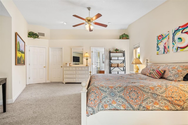 bedroom featuring vaulted ceiling, light colored carpet, ceiling fan, and connected bathroom