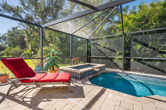 view of swimming pool featuring an in ground hot tub, glass enclosure, and a patio