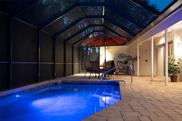 view of swimming pool featuring a lanai and a patio