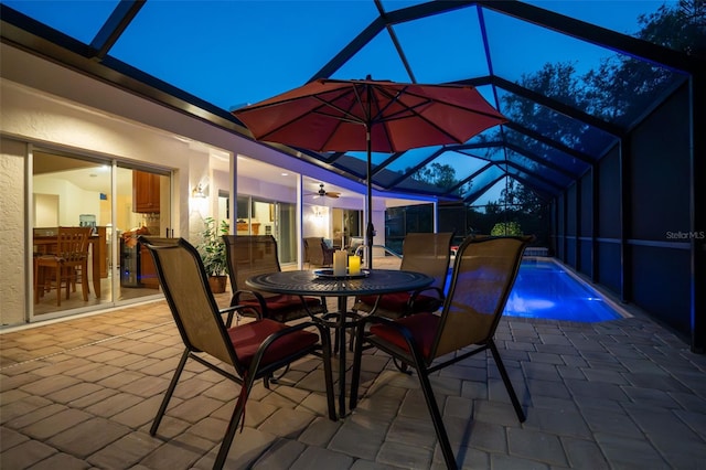 view of patio / terrace with a lanai and ceiling fan