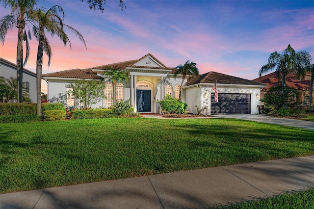 7555 Tori Way, Lakewood Ranch, FL 34202 - mediterranean / spanish home with a yard and a garage