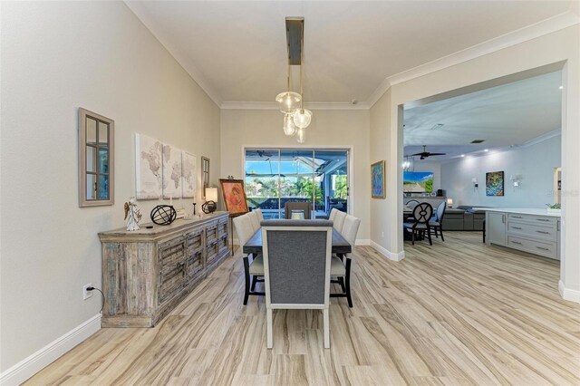 dining room featuring ceiling fan, crown molding, and light wood-type flooring