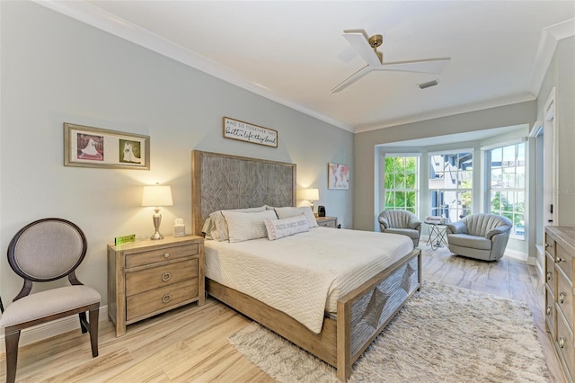 bedroom with ceiling fan, light hardwood / wood-style floors, and ornamental molding